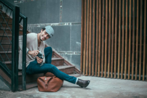 boy sitting on staircase with camera