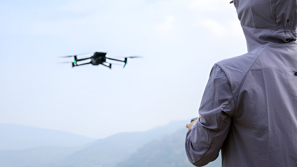 Flying drone in spring forest