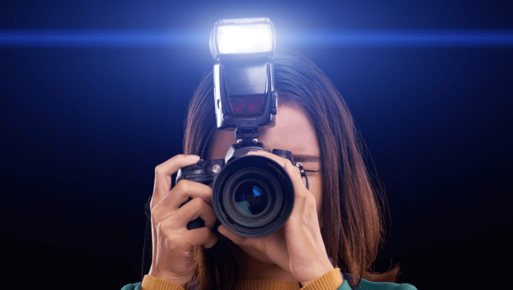 Girl using a camera with an external flash