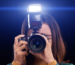 Girl using a camera with an external flash