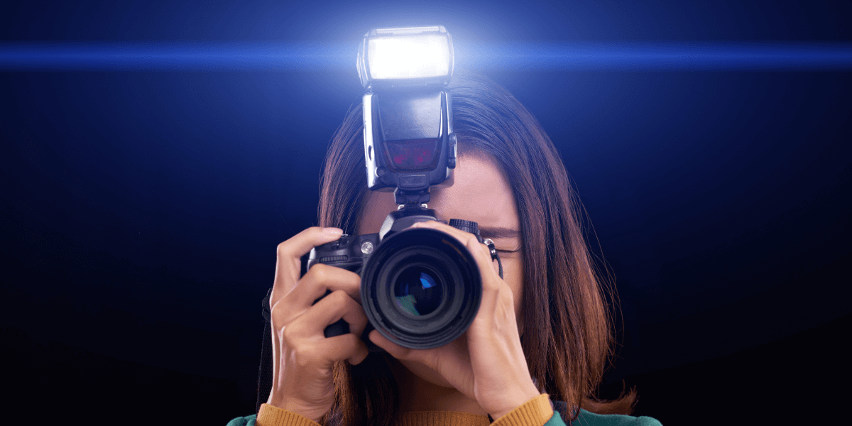 Girl using a camera with an external flash