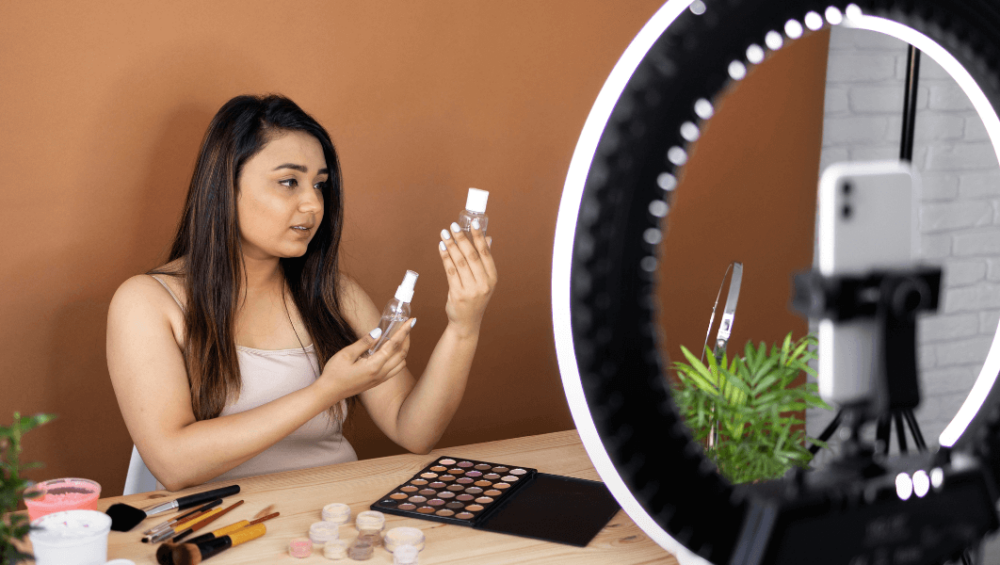 Young Woman creating the content with the help of ring light.