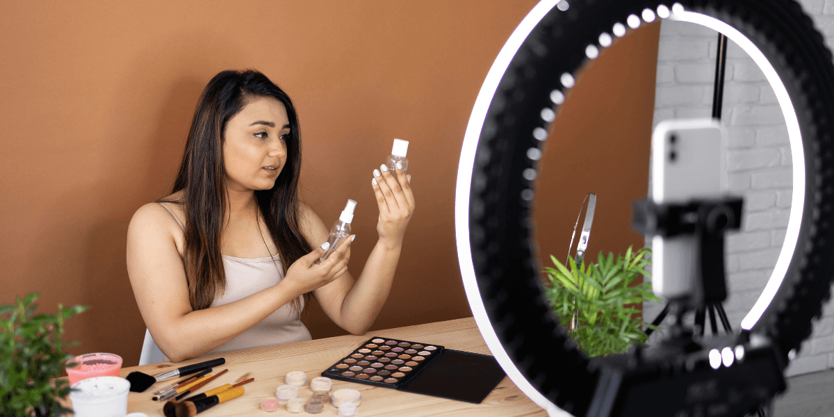 Young Woman creating the content with the help of ring light.