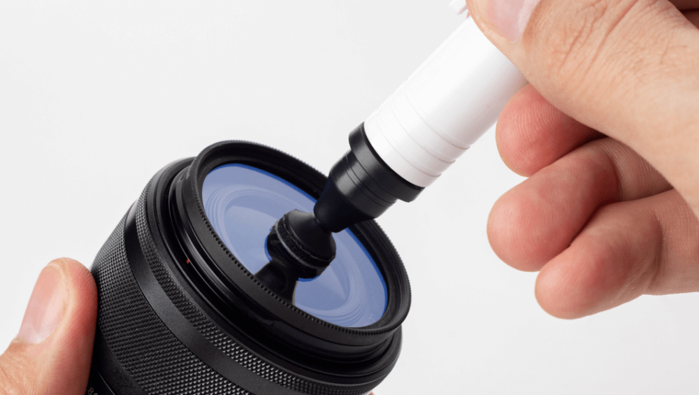 Camera lens being cleaned inside a frame.