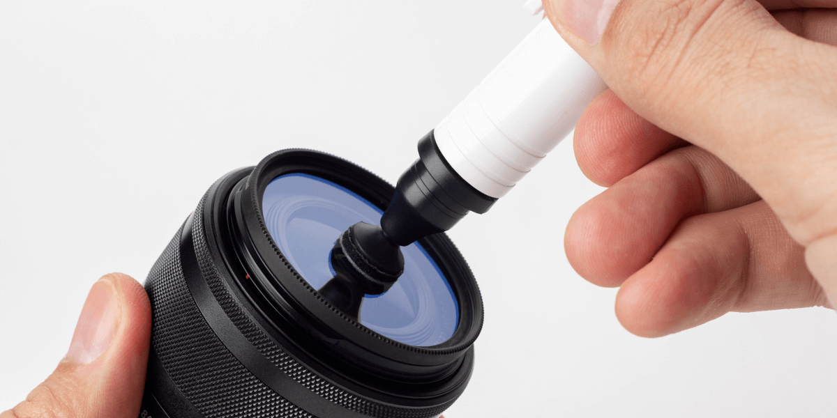 Camera lens being cleaned inside a frame.