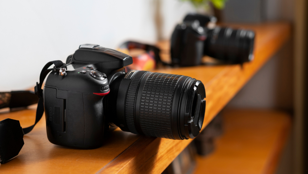 Two cameras placed side by side on a table