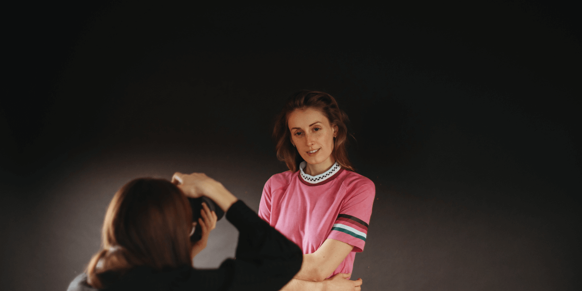 woman-taking-picture-of-another-woman-with-camera