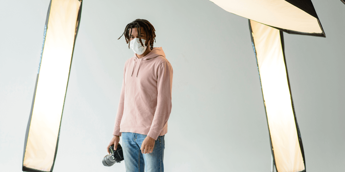 main-standing-with-a-camera-in-hand-around-lights